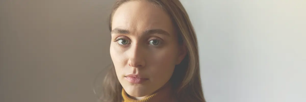 Young woman with a serious expression looking at camera