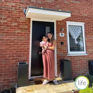 mother and baby outside life house